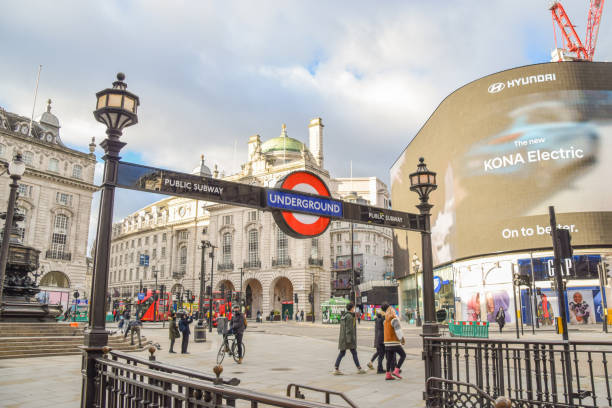 London, United Kingdom - December 24 2020: Entrance to Piccadilly Circus Underground Station, daytime view with people.
