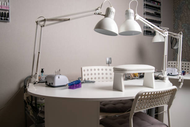 istock Beauty salon interior, no people. Manicure workplaces with professional tools 1295784223