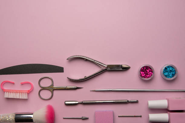 istock Set of manicure tools and accessories on a pink background. Hardware manicure,Flat lay. 1295784236