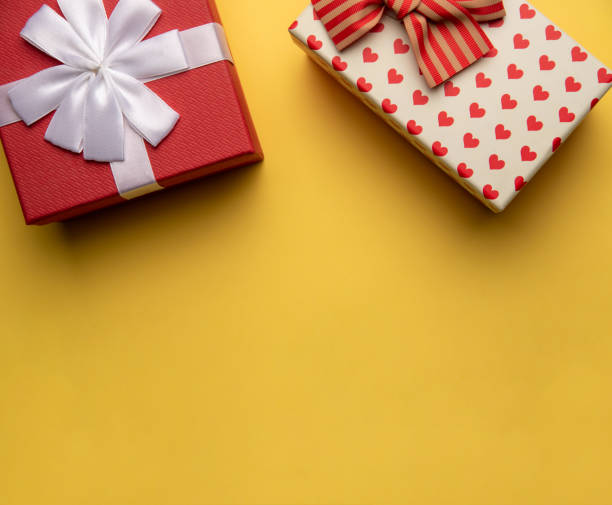 istock Red and white gift box with on yellow background,flat lay 1295784342