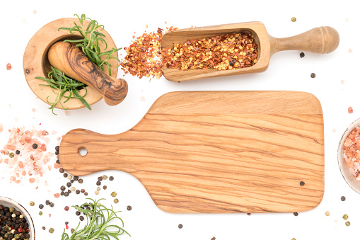 cutting board with ingredients and spices isolated on white background