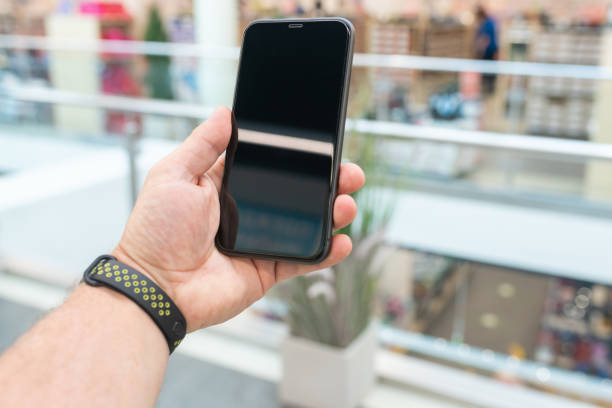 istock Smartphone with a blank screen in a man's hand 1295784561
