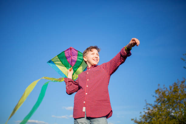 istock Teenager launches a kite 1295784707