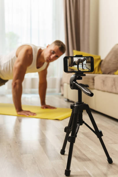 istock Fitness blogger streaming or recording video for his subscribers 1295785818