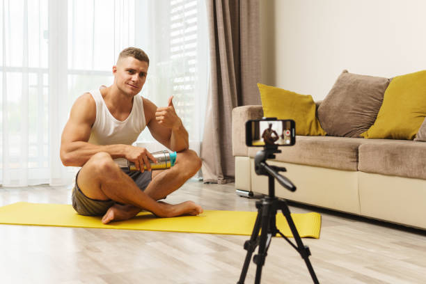 istock Fitness blogger streaming or recording video for his subscribers 1295785833