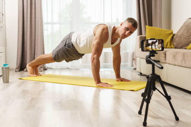 istock Fitness blogger streaming or recording video for his subscribers 1295785878