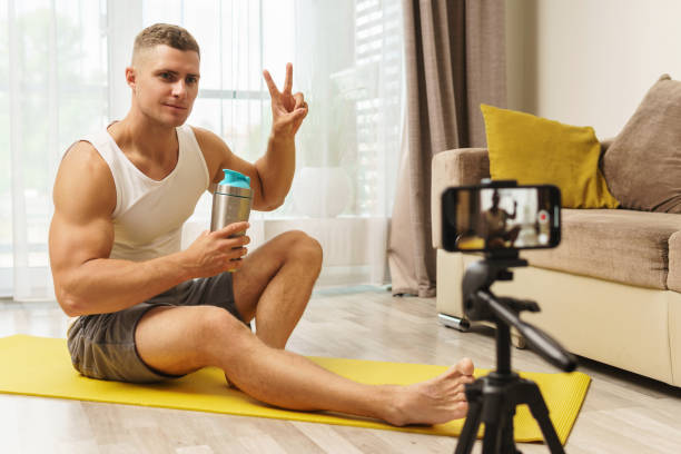 Fitness blogger streaming or recording video for his subscribers