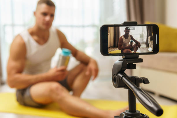 istock Fitness blogger streaming or recording video for his subscribers 1295786030