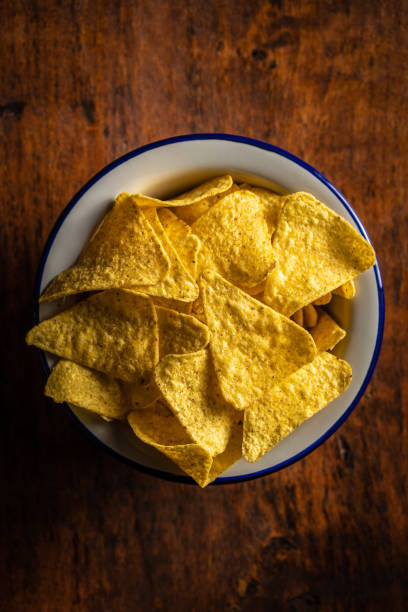 istock Salted tortilla chips. Yellow nachos triangle. 1295786216