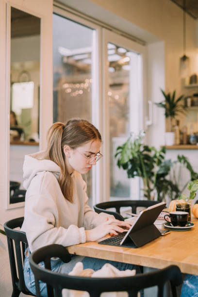 istock Teenager doing homework at cafe 1295787027