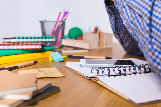 istock Young man sitting at the table and studying from home 1295787649