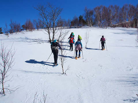 Snow covered mountain slope under the clear blue sky in the winter