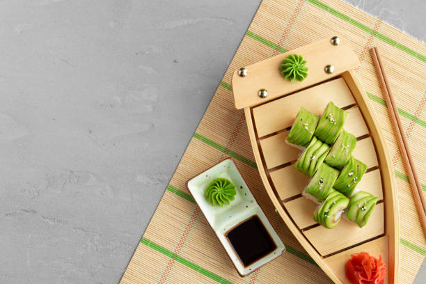Dragon sushi roll covered with avocado pieces