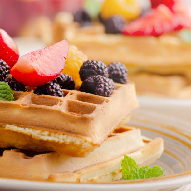 istock CLoseup view at belgian waffles served with strawberries and blackberries on kitchen table 1295788991