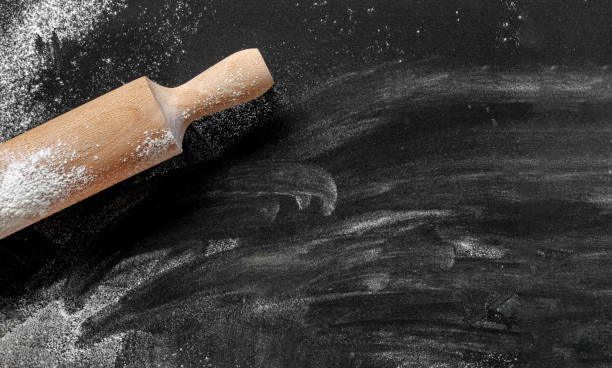 istock Dark background with flour and rolling pin 1295790048
