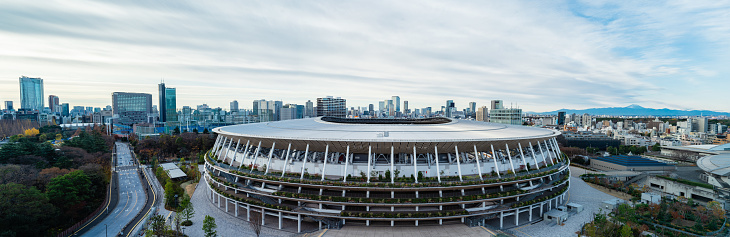 Tokyo, Japan - December 2020: The New National Stadium for Tokyo 2020 Olympics. A panoramic image of Mt. Fuji in the distant view.