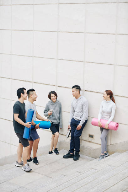 istock Young people discussing yoga training 1295790450
