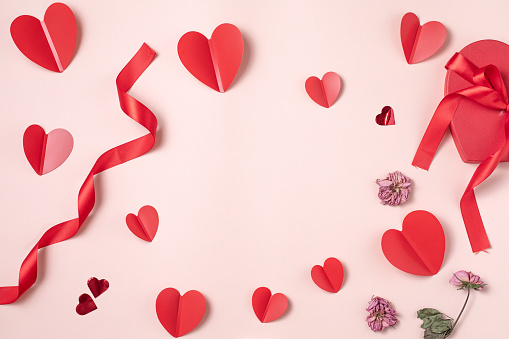 Valentine day composition with red hearts on pink background.