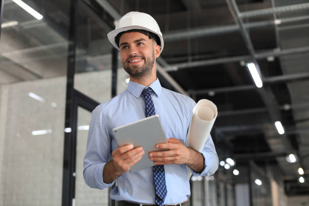 Shot of a engineer using a digital tablet on a construction site. Shot of a engineer using a digital tablet on a construction site engineer stock pictures, royalty-free photos & images