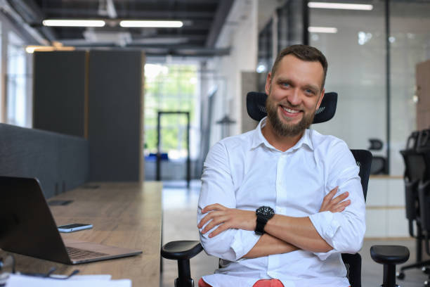 istock Young handsome businessman smiling in an office environment. 1295791416