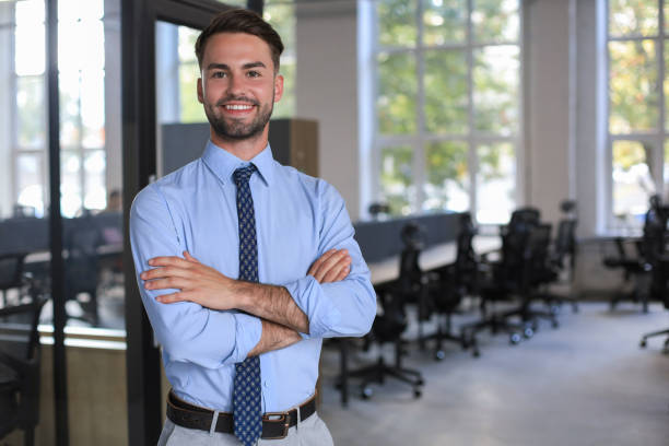 istock Young handsome businessman smiling in an office environment 1295791634