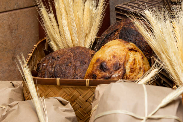 Homemade breads exposed on wooden table.