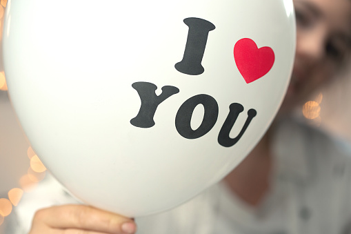 White balloon with I love you written on with sparkling bokeh background, Valentine's day concept design romantic love