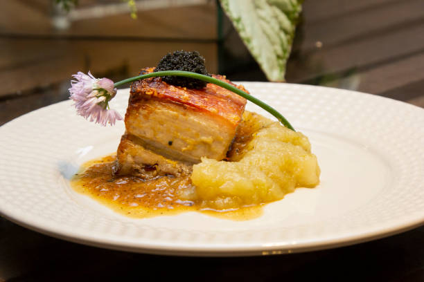 istock Pork belly with green apple puree and caviar 1295792430