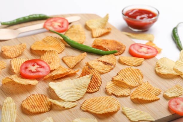 istock Potato chips with tomato ketchup isolated on white background 1295793206