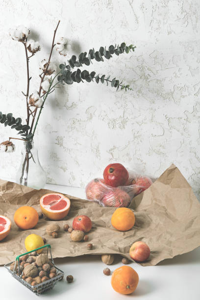 istock Still life. Mix fruit and nut, flowers on the table 1295794173