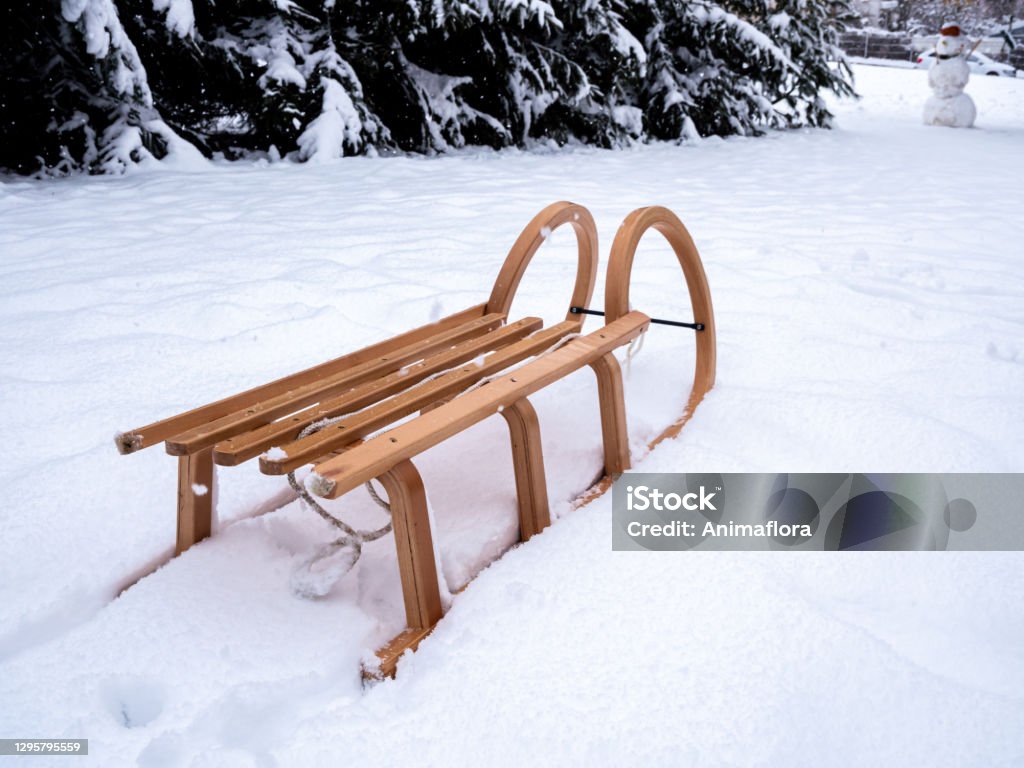 Wooden sledge in a wintry landscape on the mountain"n Wooden sledge in a wintry landscape on the mountain Sled Stock Photo