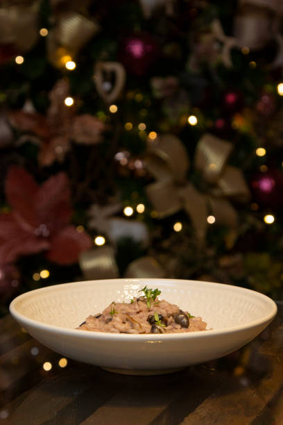 istock Mushroom risotto on the wooden table on christmas background. 1295795973