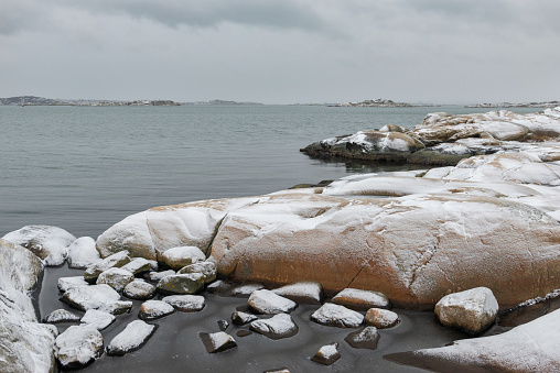 Snow on the rocks in Swedens archipelago. Fiskeback in Gothenburg.