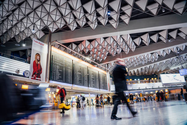 Frankfurt, Germany - October 16, 2019: People in motion blur walking through the Departure Hall of Frankfurt Airport Terminal 1, largest Airport of Germany.