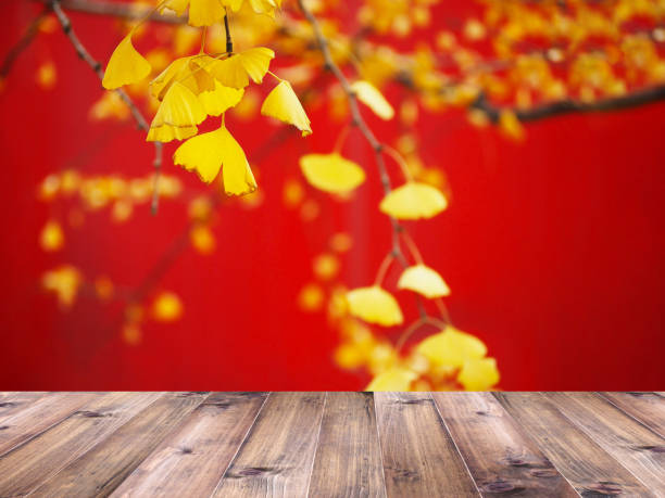 istock Wood table top over yellow ginkgo leaves 1295801439