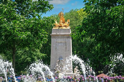 Saint Petersburg, Russia - June 09, 2023: Golden monuments with fountains and Grand Palace in Petergof park near St. Petersburg. Built in 18th century laid out on the orders of Peter the Great. The palace-ensemble with fountans, gardens and monuments is recognised as a UNESCO World Heritage Site.