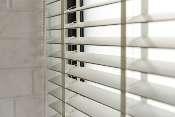 istock Close-up open venetian blinds. lighting range control sunlight coming from a window. decoration interior. Modern jalousie. 1295804550