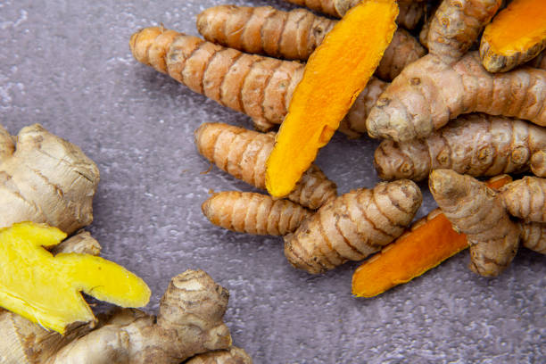 istock Fresh turmeric root, ginger, oranges and lemon on a grey slate background. 1295805138