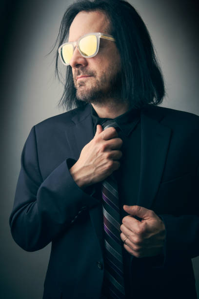 istock Handsome Man in Suit Wearing Mirrored Shades 1295805756