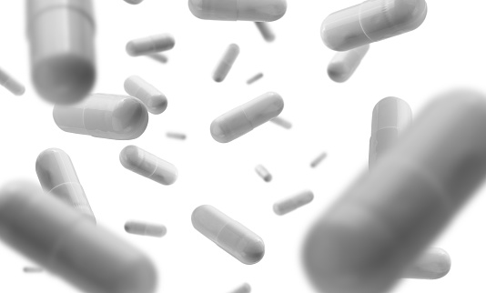 Capsules with the drug levitate on a white background.