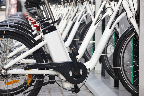 urban electric bikes charging batteries in the city. transportation - electric bicycle imagens e fotografias de stock