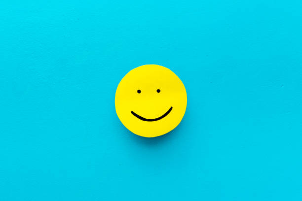 istock Happy face emotion concept. Happy face on paper banner, top view 1295809876