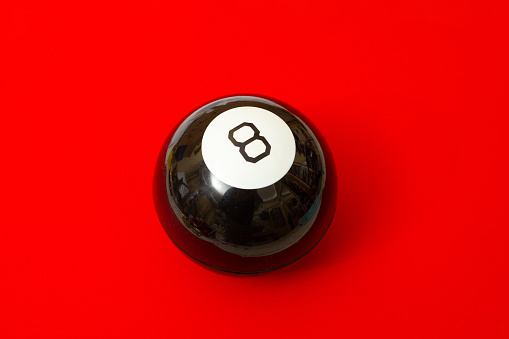 Magic ball of predictions billiard eight on a red background.