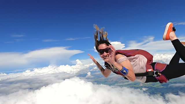 Image of a woman parachutist in casual clothing smiling