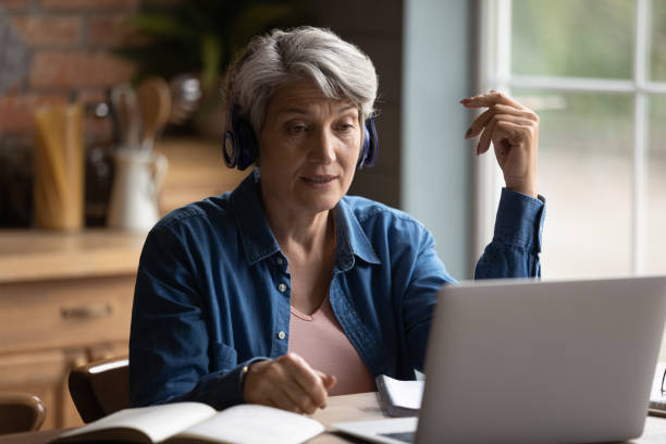 istock Focused middle aged mature woman studying distantly. 1295813935