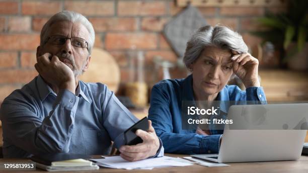 Unhappy Older Senior Family Couple Thinking Of Financial Problems Stock Photo - Download Image Now