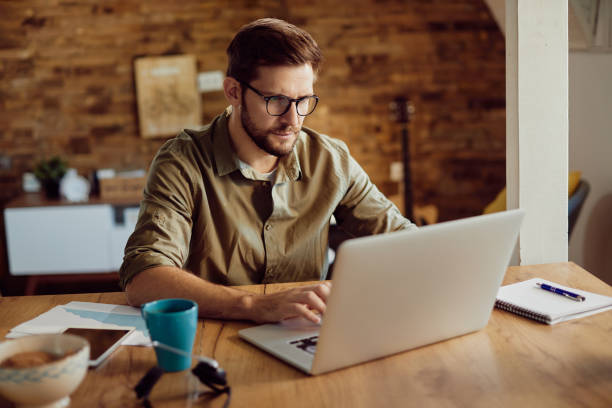 istock Male entrepreneur working on a computer at home. 1295814699