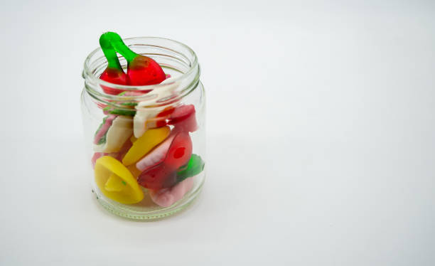 istock glass jar with colored jelly beans, on white background 1295814895