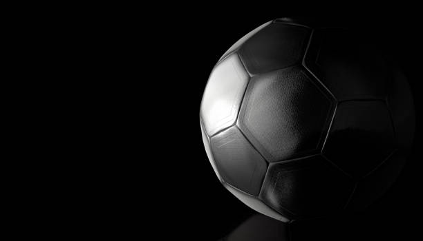 istock Soccer ball with metallic appearance on a reflective black surface. 3d illustration 1295816227