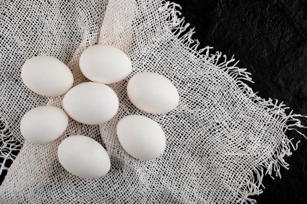 istock Pile of uncooked fresh eggs on burlap 1295816629